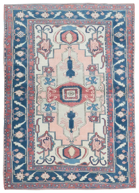 Full overhead view of the pink and navy vintage Anatolian rug on a white background