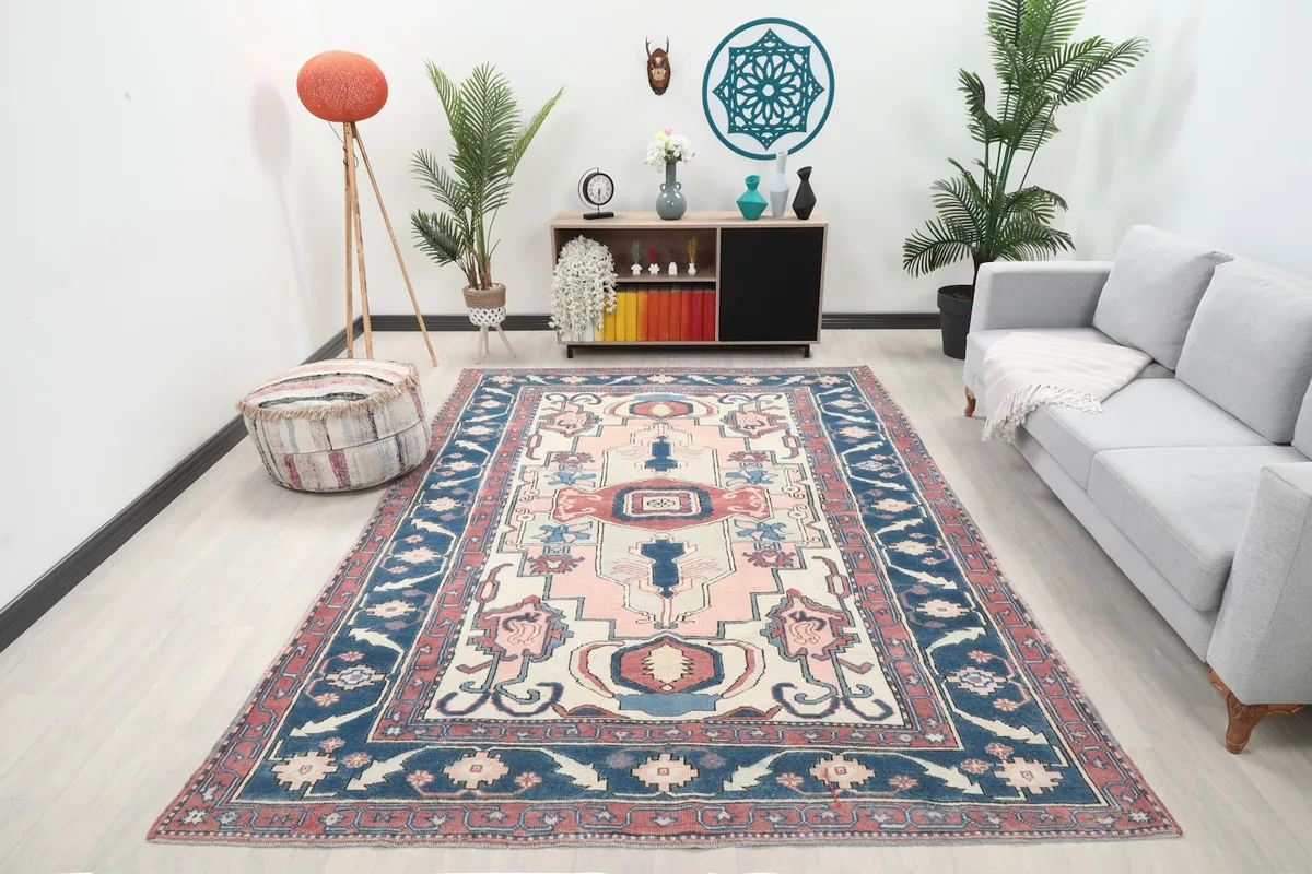 Vintage Anatolian rug with pink and navy colors in a modern living room setting