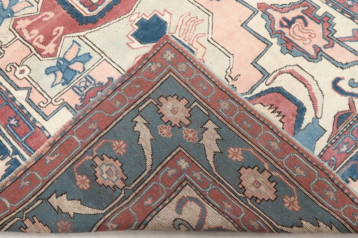Folded corner of the rug, showing the reverse side and the hand-knotted construction