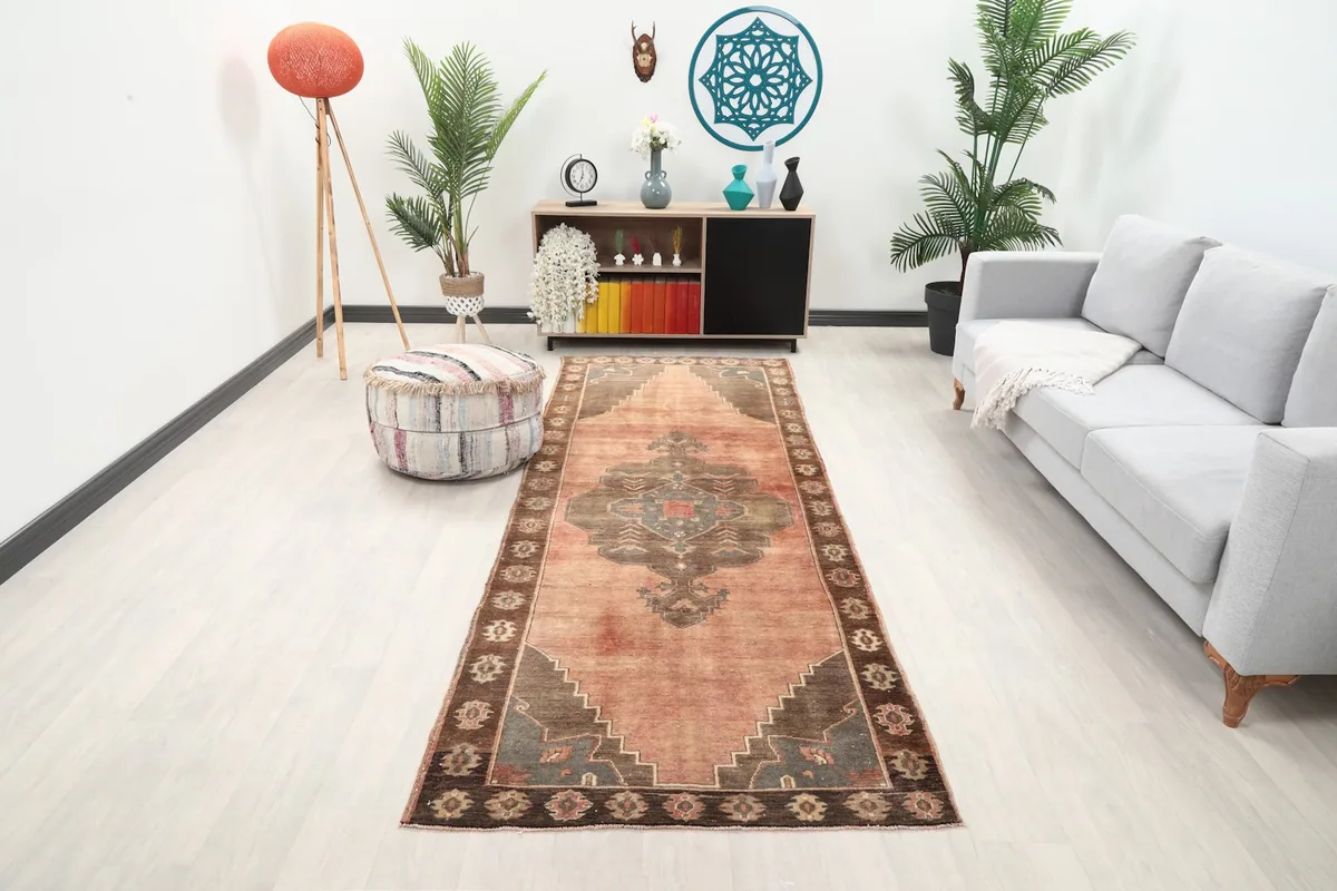 Rust and brown vintage runner rug displayed in a modern living room setting.
