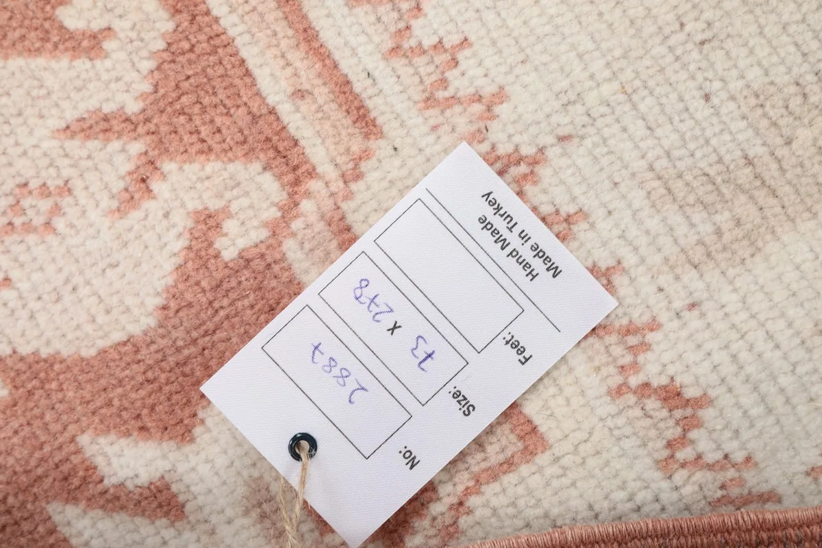 Label showing the rug's size in feet and centimeters, and hand-made origin