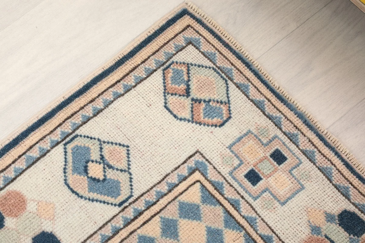 Detailed view of the rug's outer border and corner motifs