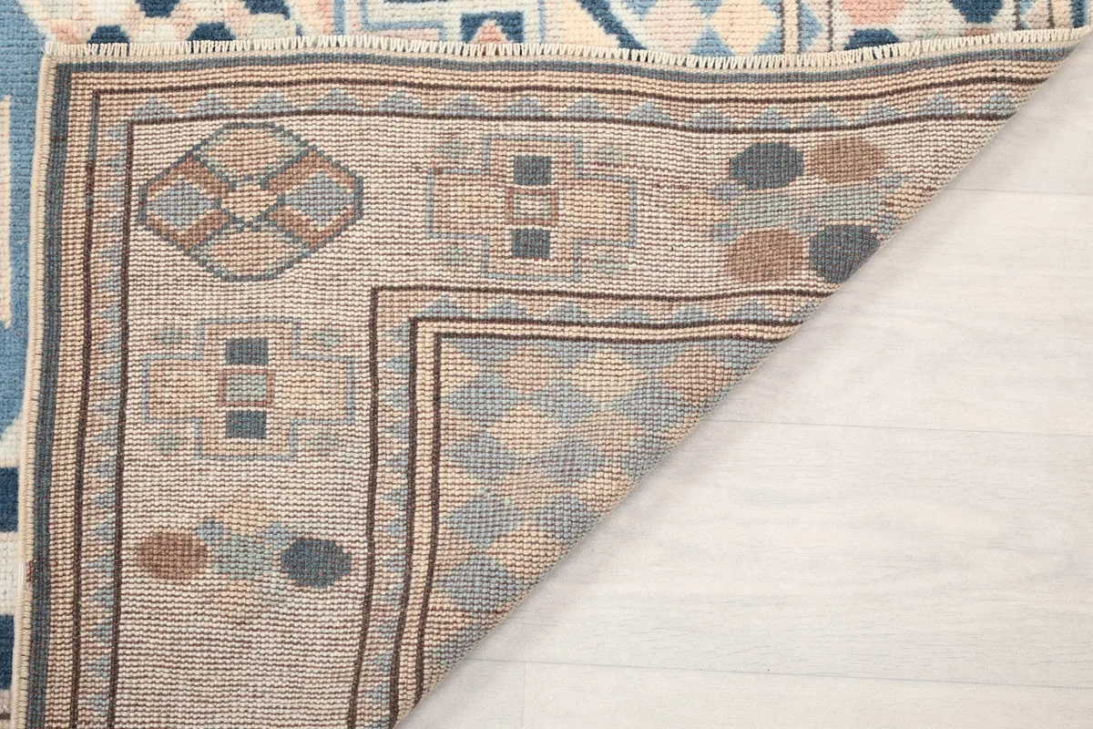 Underside of the rug showing the hand-knotted construction and foundation