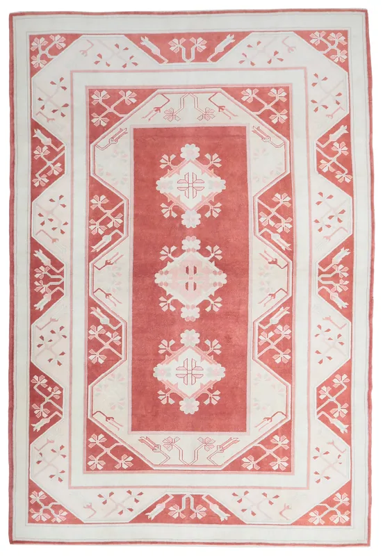Full overhead view of the rose and cream Anatolian vintage rug on a white background.