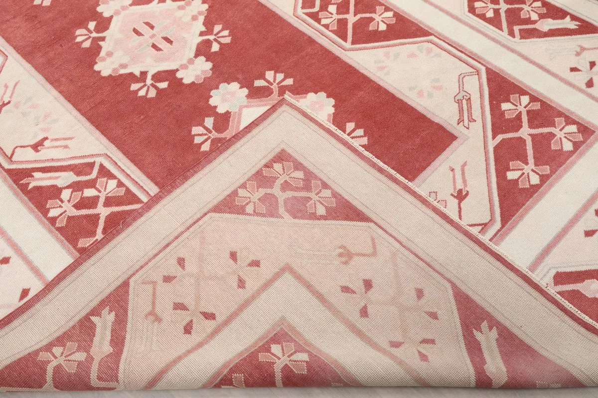 Folded corner of the rug, revealing the thickness of the wool pile and cotton foundation.