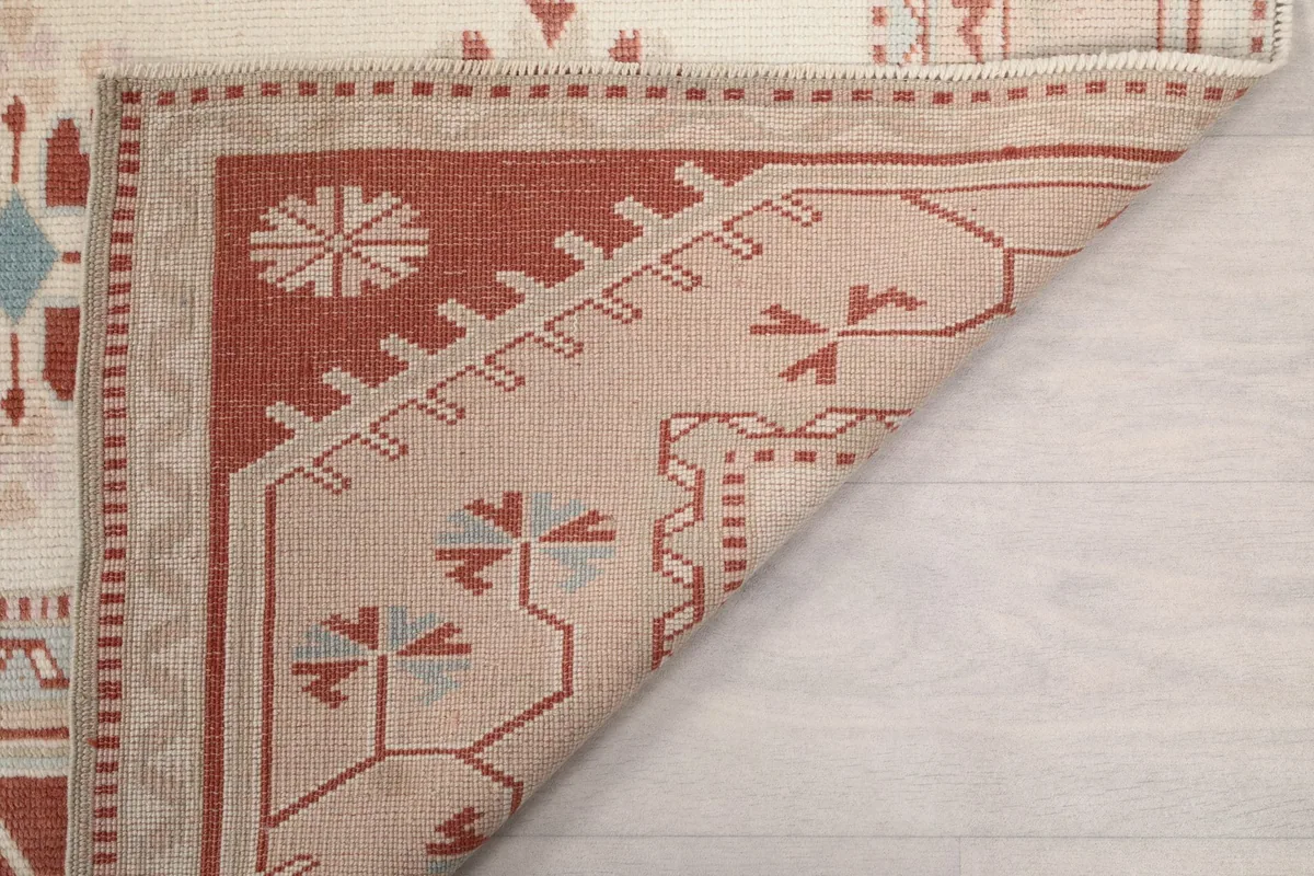 Underside of the rug, showing the hand-knotted construction and foundation materials