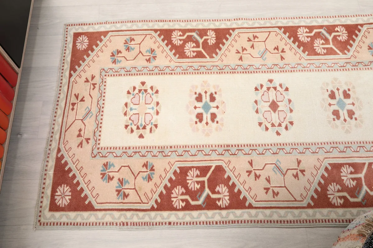 Overhead shot of the rug's design, showing the repeating medallions and border patterns