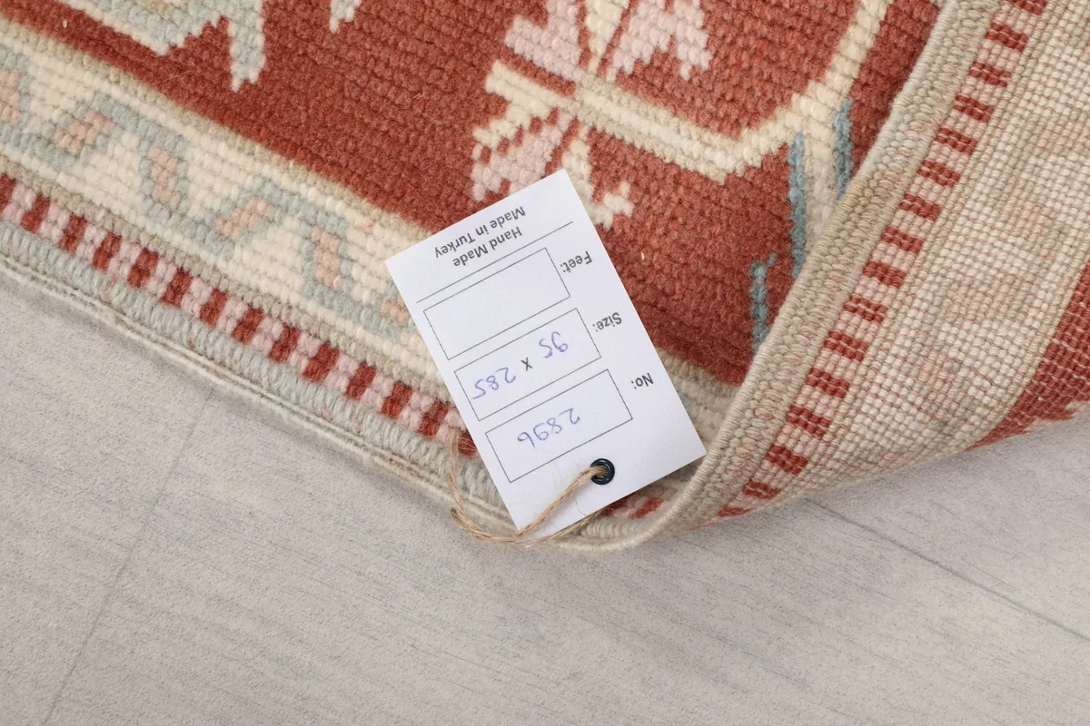 Rug label showing the size 95 x 285 cm and origin, indicating its hand-knotted vintage quality