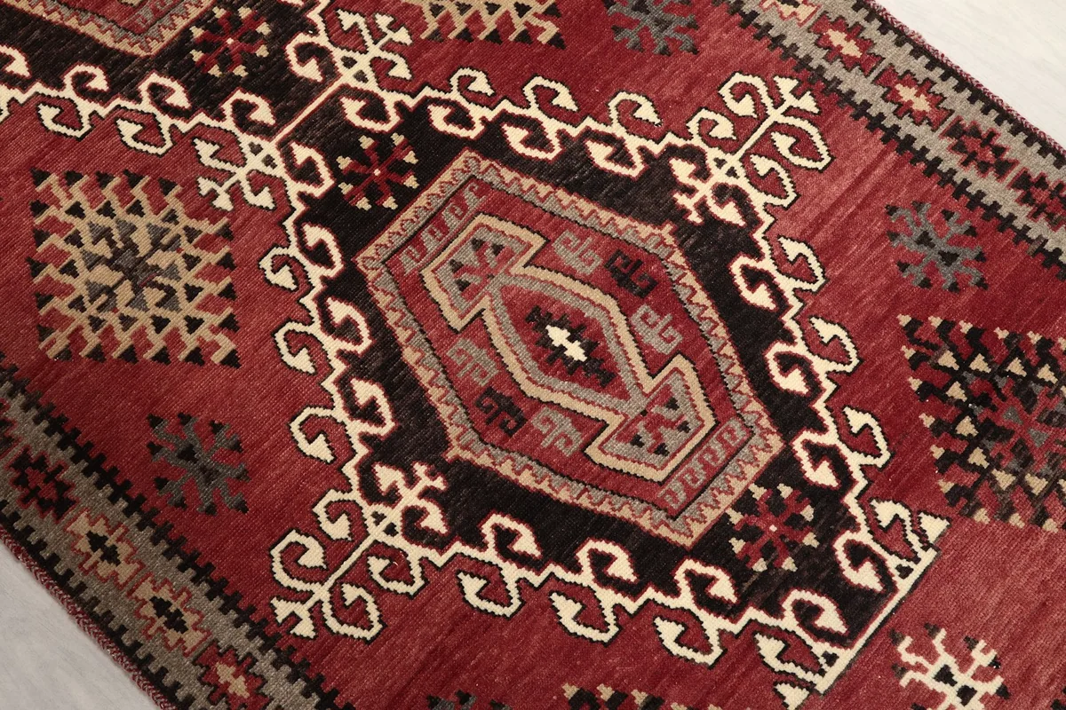 Close-up of the central black geometric medallion and surrounding tribal motifs