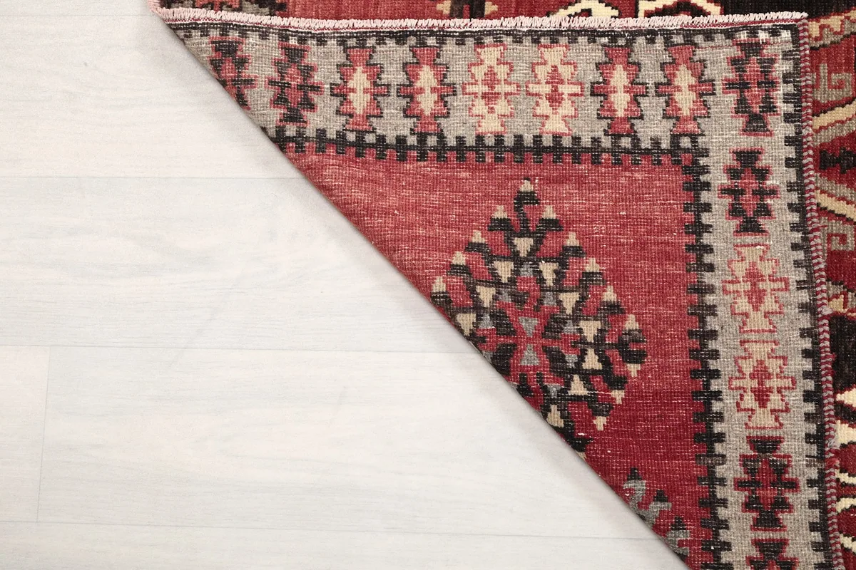 Underside of the rug, revealing the tightly woven cotton foundation and knotting