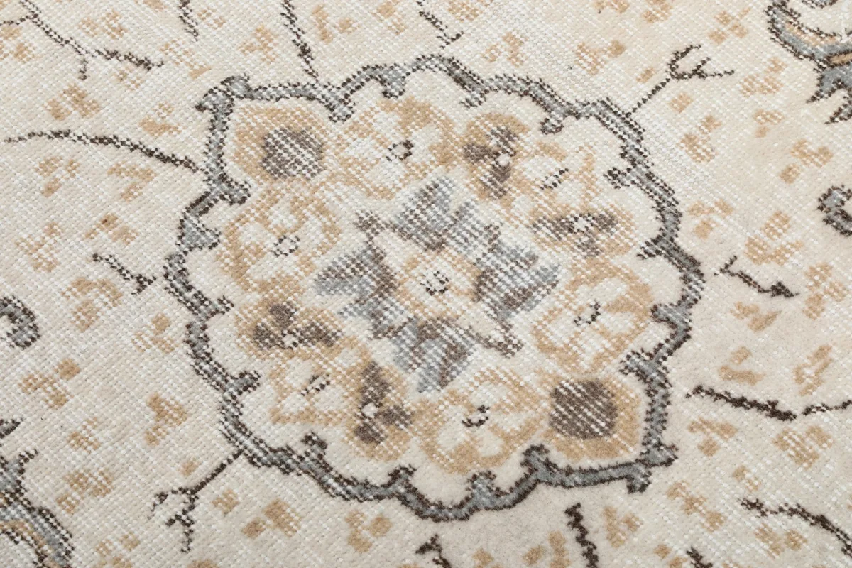 Extreme close-up of the central medallion with gray and tan tones