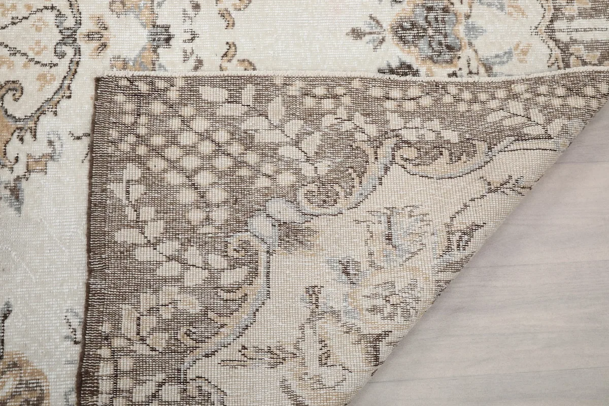 Another view of the rug's back, showing the construction and fringe