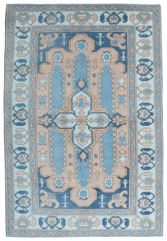 Full overhead view of the blue and tan vintage Anatolian rug on a white background.