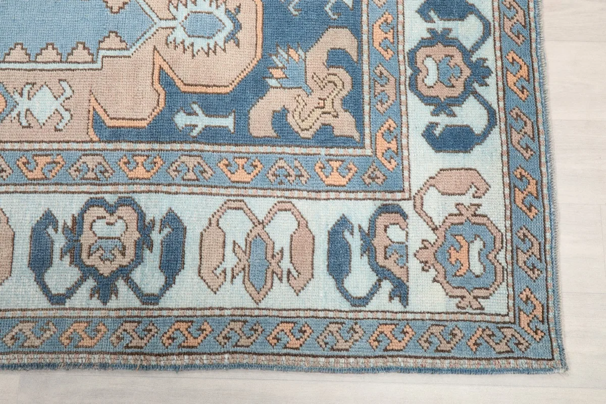 Detailed view of the rug's corner, showcasing the intricate border design and colors.
