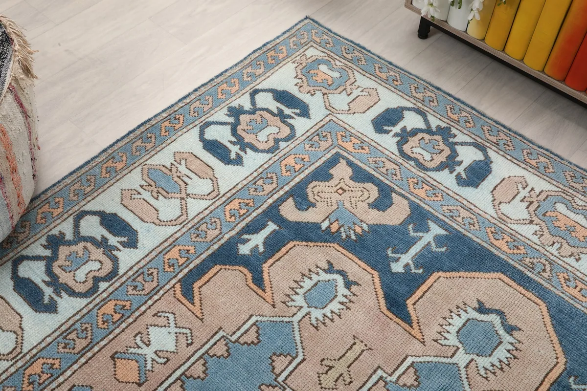 Close-up of a rug corner, detailing the border patterns and color transitions.