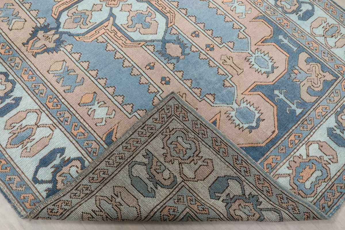 View of the rug's back, showing the cotton foundation and hand-knotted construction.