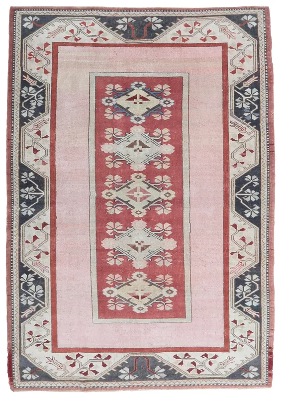 Full top view of the 5'5" x 8'0" vintage pink and red Anatolian area rug