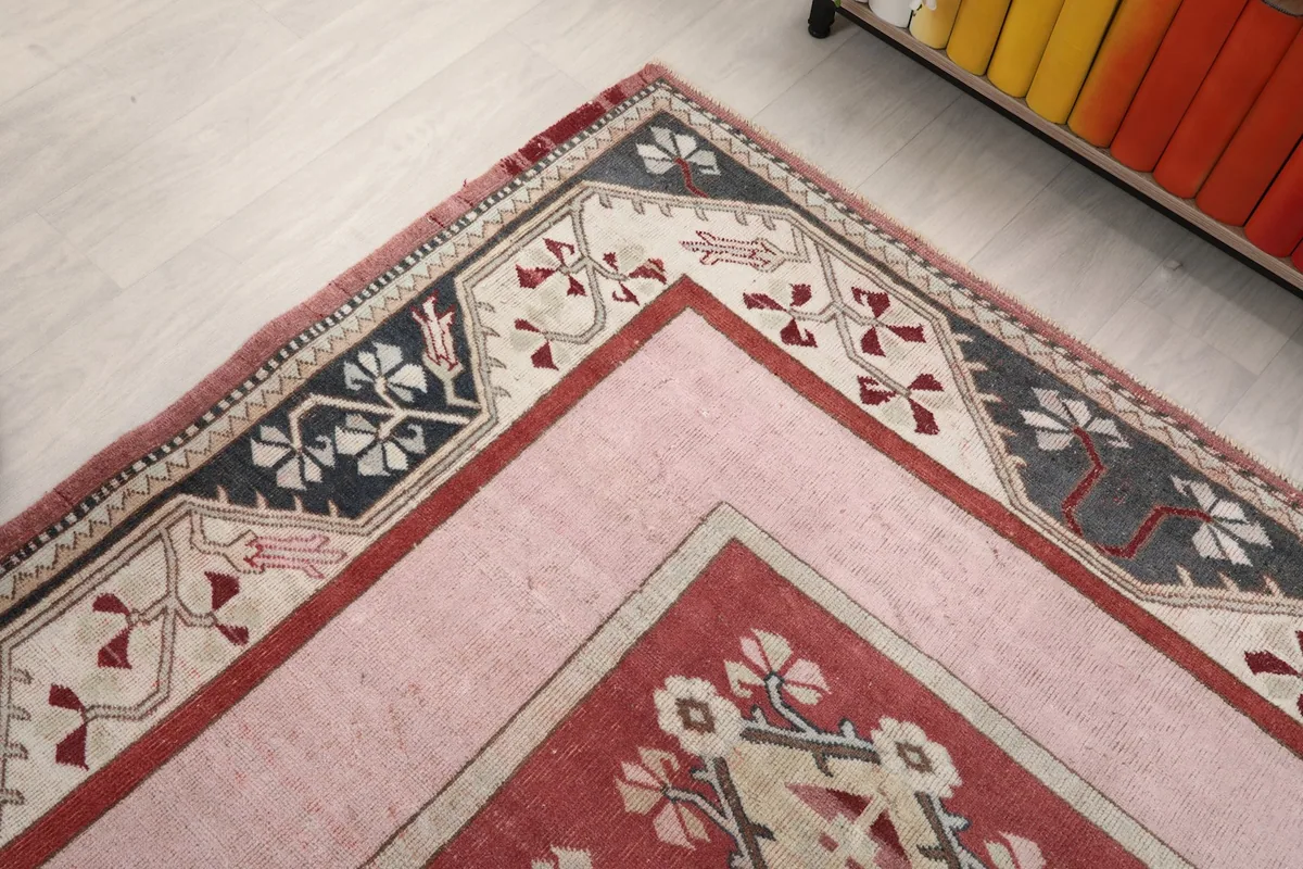 Corner detail showing the intricate border work and the pink field
