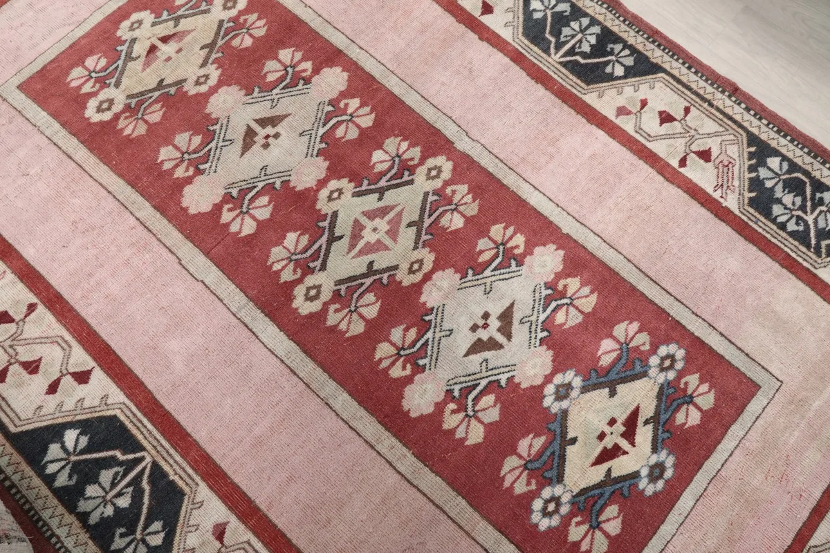 Close-up of the central red panel with geometric and floral motifs