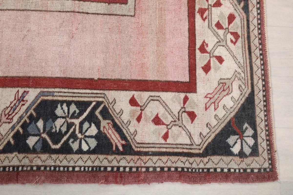Detail of the navy and beige floral border design on the corner of the rug