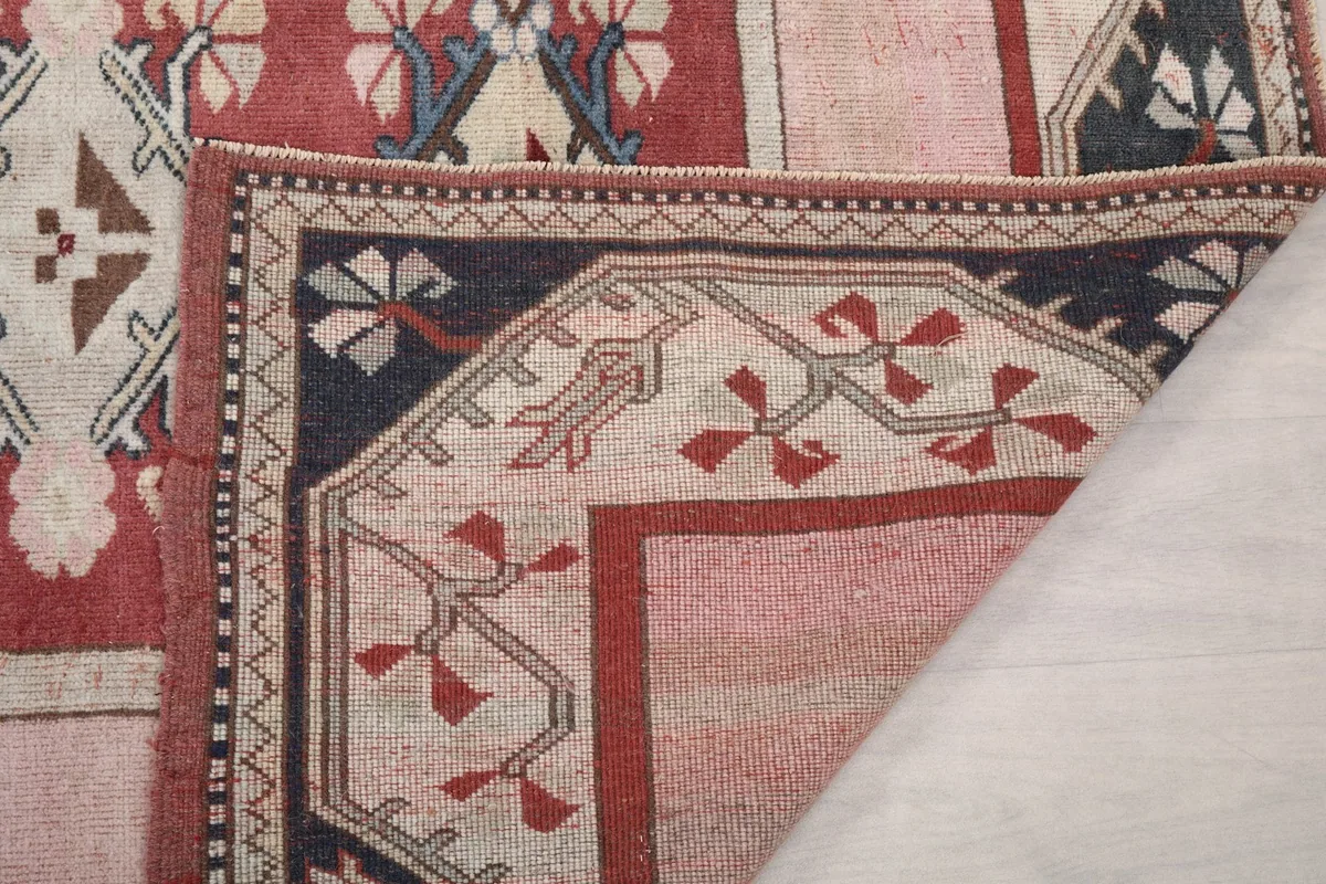 Close-up of a folded corner, showing the back of the rug and knotting