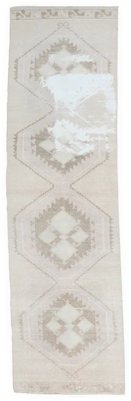 Full overhead view of the beige and tan vintage Anatolian runner rug