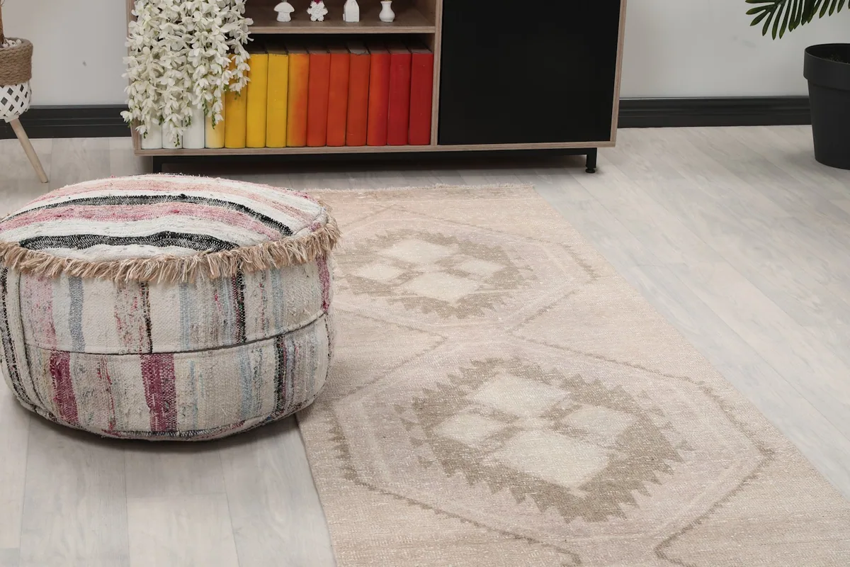 Close-up view of the runner's geometric pattern and texture next to a pouf