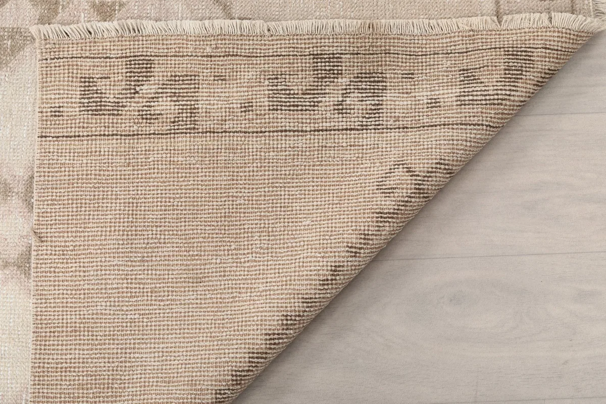 Detailed view of the rug's reverse side, revealing the knotting and foundation