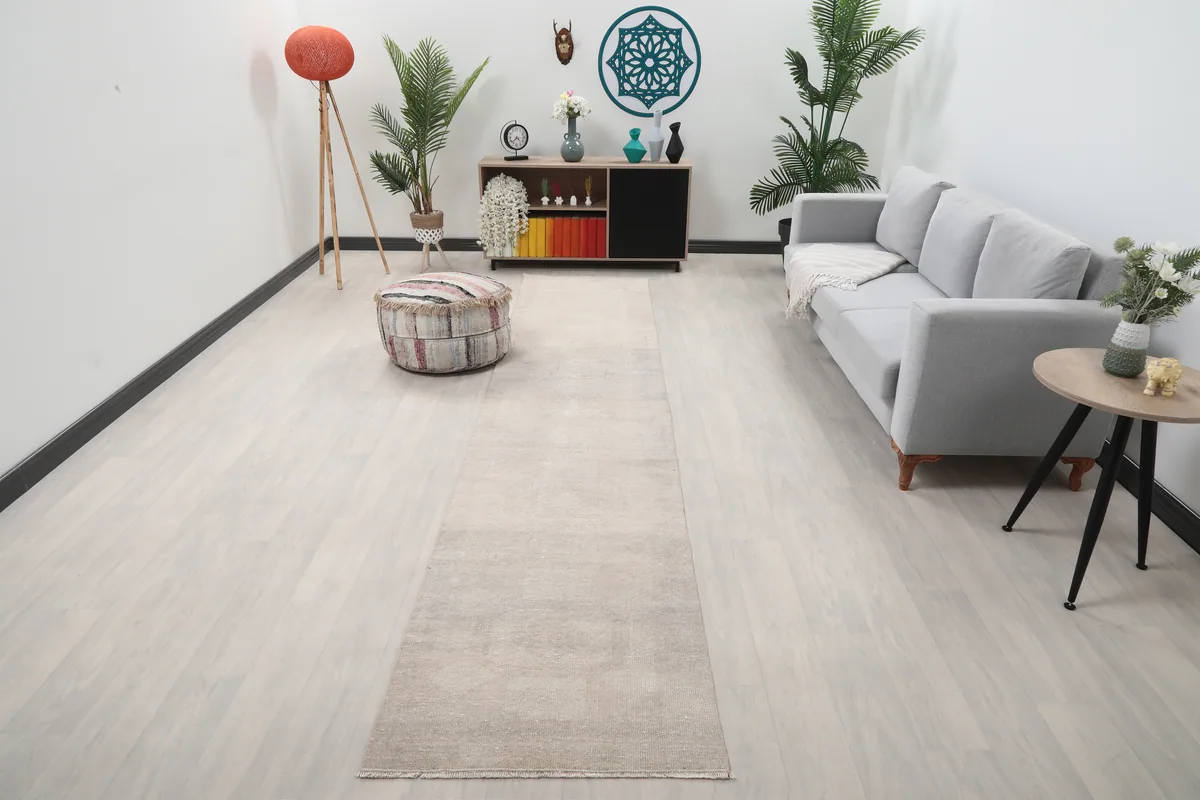 Beige Distressed Anatolian Runner in a modern living room setting, extending from foreground to background.