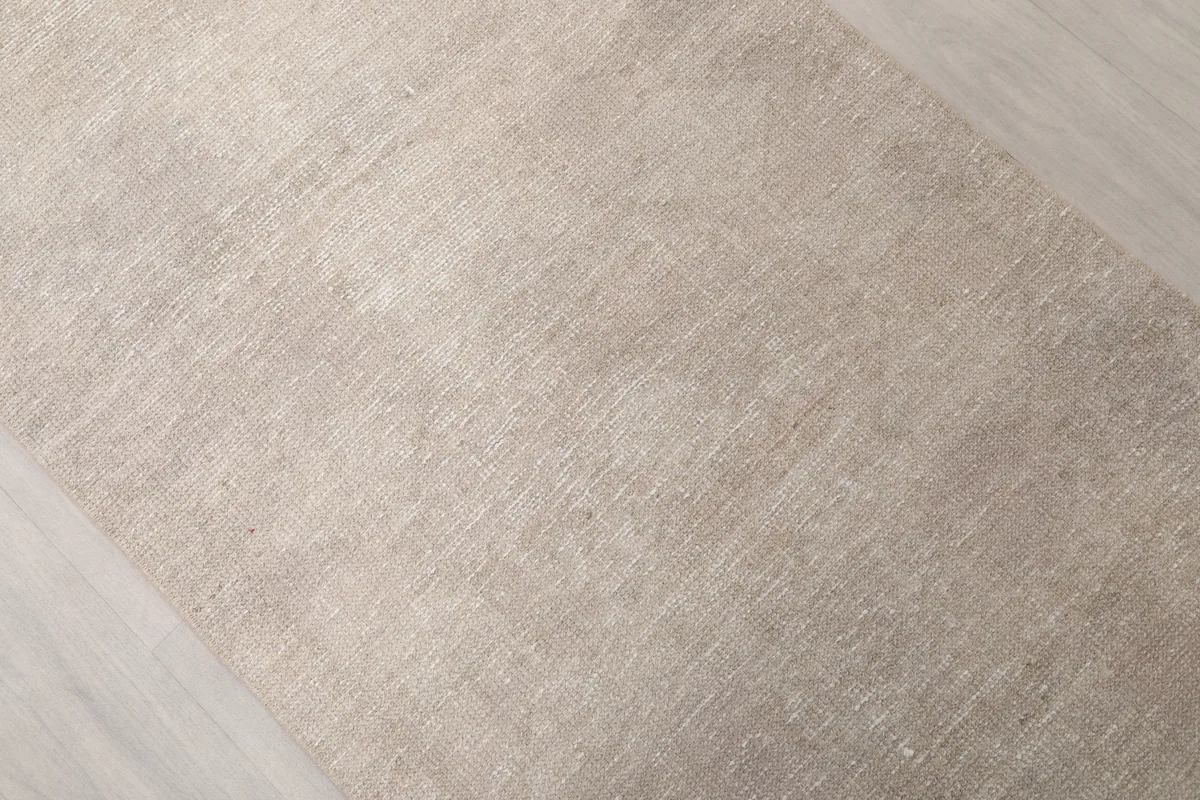 Angled view of the Beige Distressed Anatolian Runner highlighting its faded beige and gray tones.