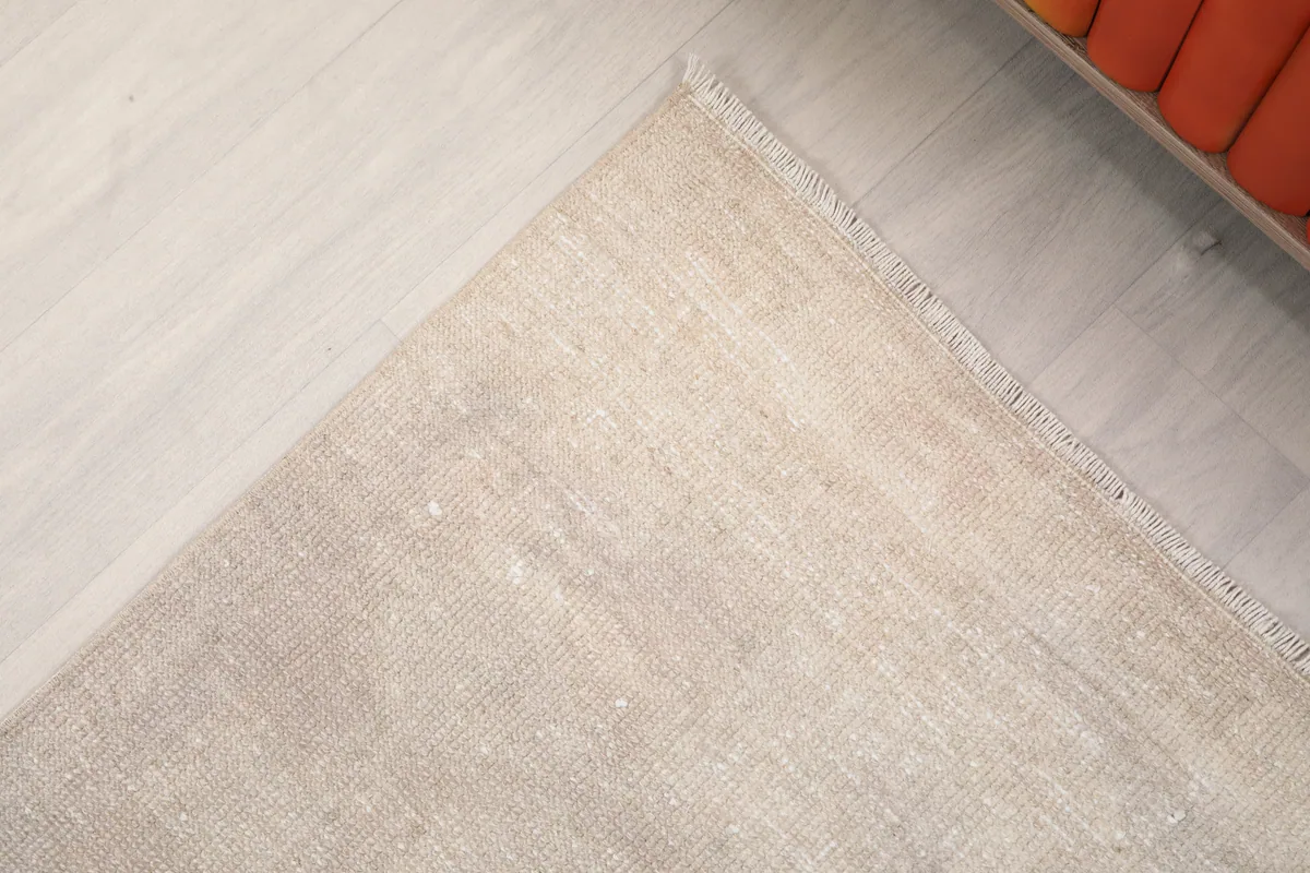 Detail shot of one end of the Beige Distressed Anatolian Runner, showing the subtle border and finished edge.