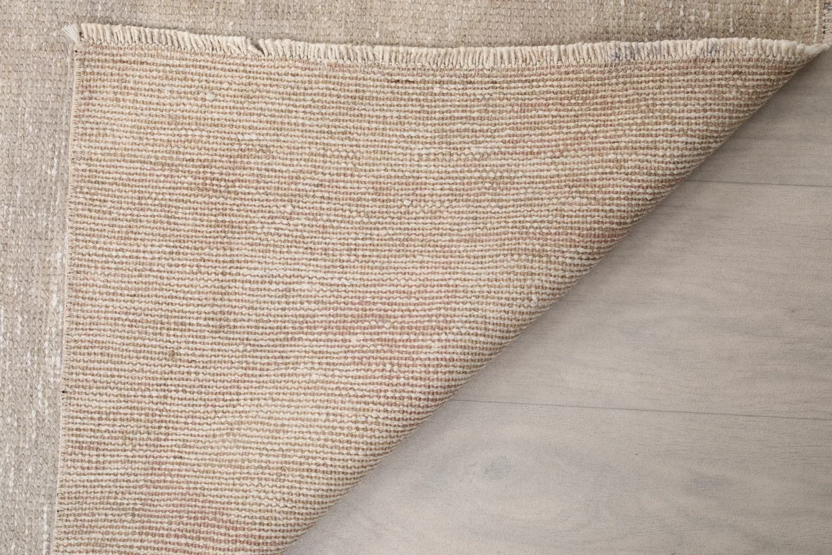 Close-up of the back of the Beige Distressed Anatolian Runner, revealing the tight knotting and foundation.