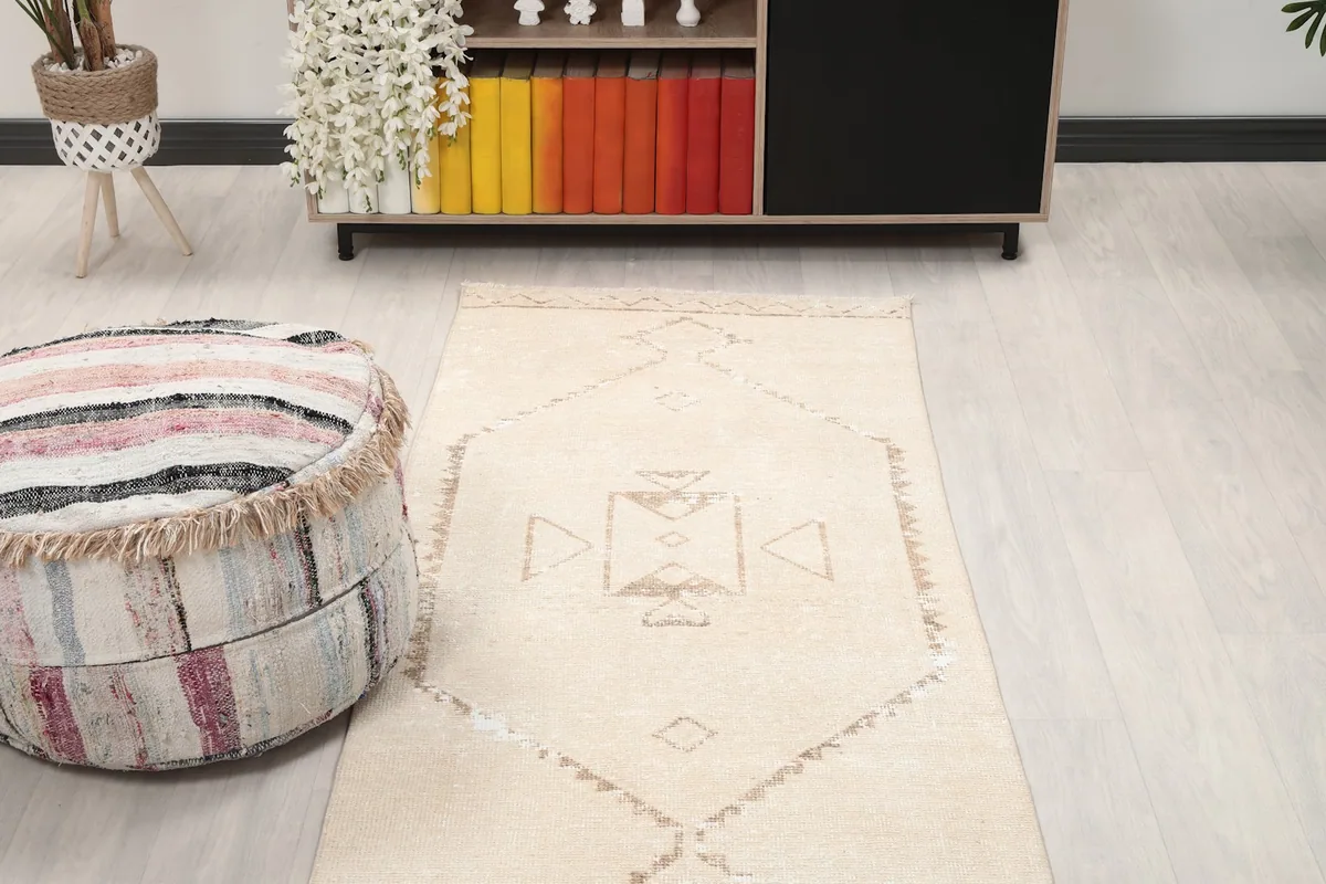 Overhead view of a section of the runner rug in a room, highlighting its placement next to furniture
