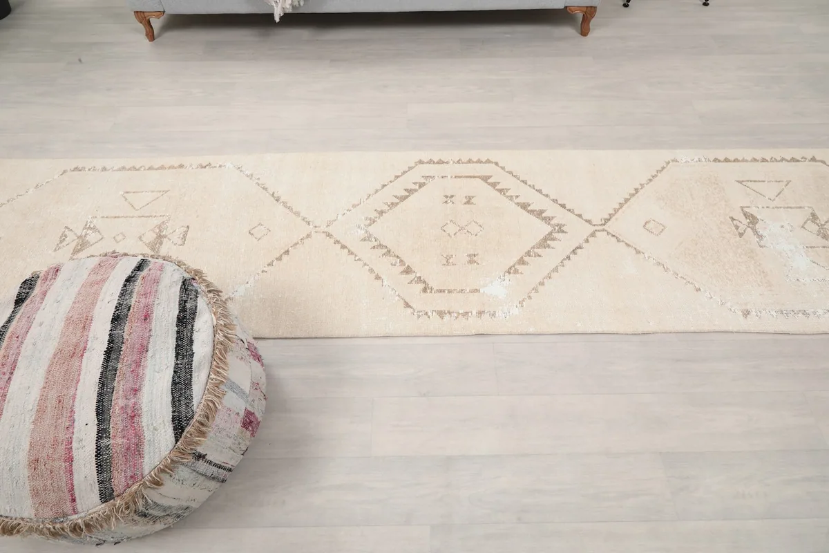 Overhead shot of the runner rug's central motifs and overall pattern in a room environment