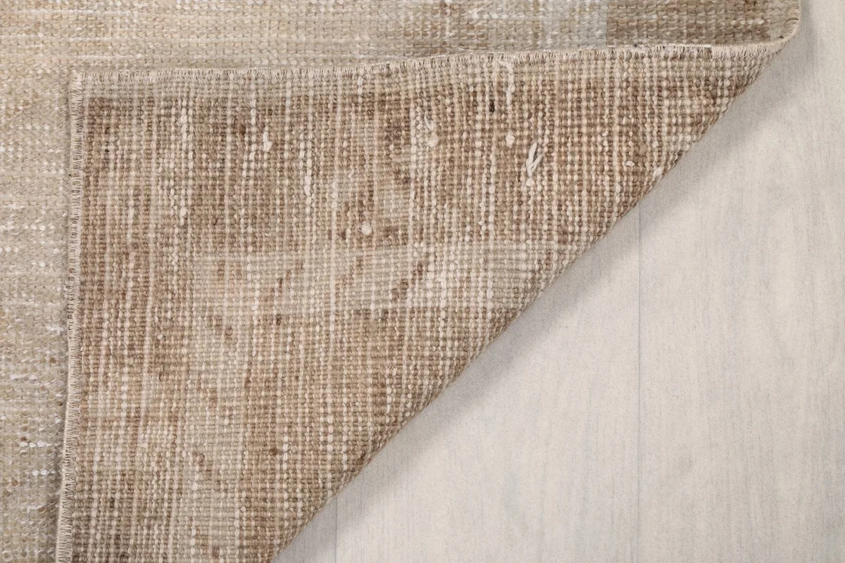 Close-up of the back of the rug, revealing the intricate hand-knotting on the cotton foundation