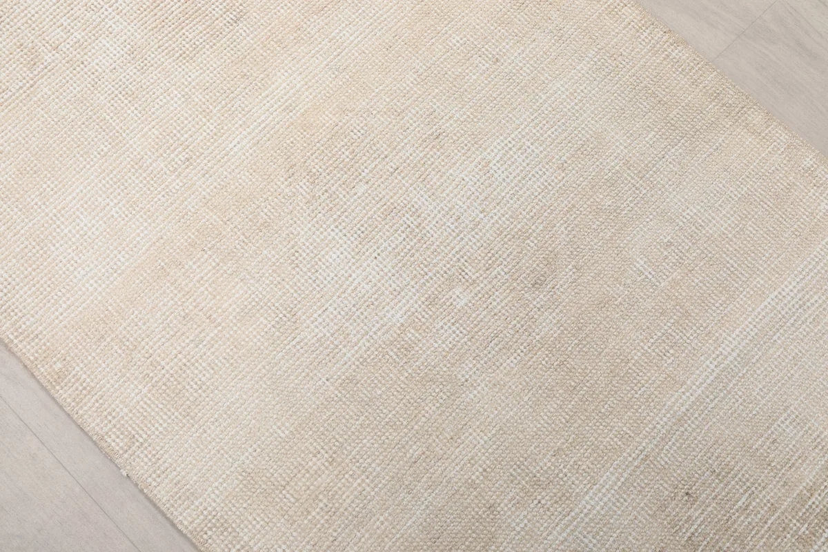 Another close-up of the rug's surface, highlighting the subtle variations and low pile.