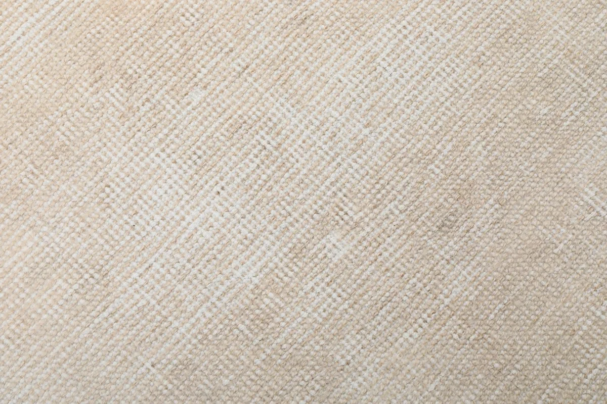 Extreme close-up of the low wool pile, showing the hand-knotted texture and natural fiber.
