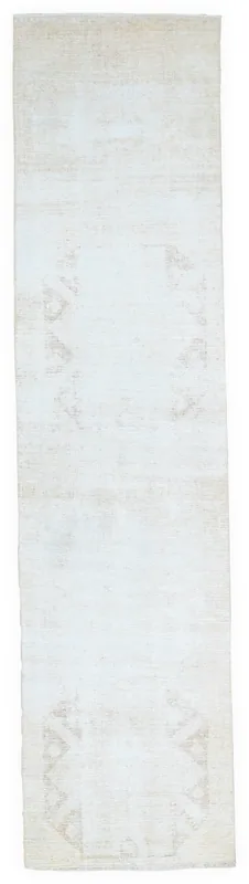 Full top view of the 2'6" x 10'6" cream and beige vintage Anatolian runner rug on a white background