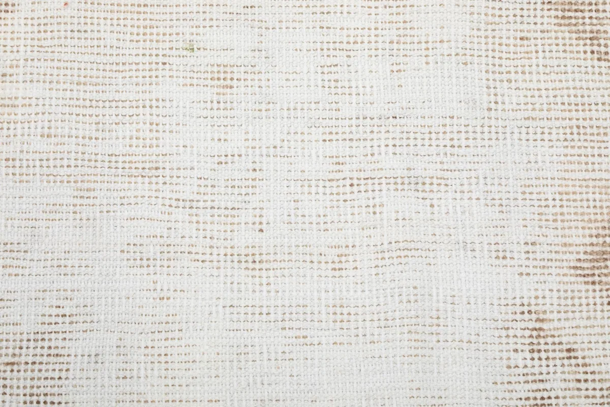 Texture of the low pile wool surface, showing the subtle variations in the cream and beige threads