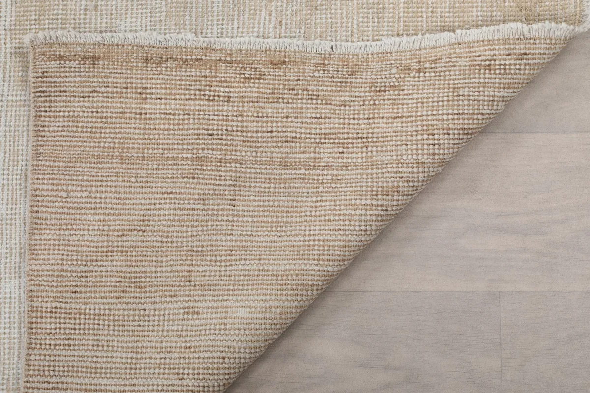 Close-up of the back of the rug, revealing the intricate hand-knotted structure and cotton foundation