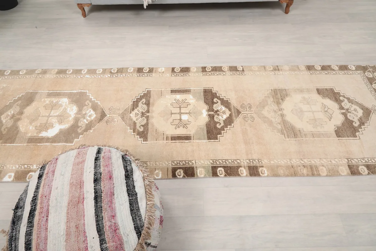 Long view of the runner rug from above, extending across the light-colored floor