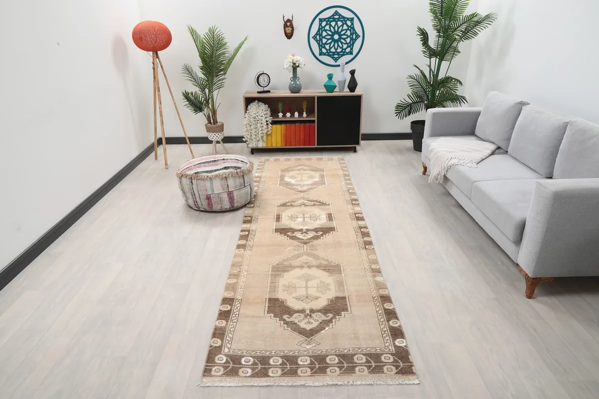 Vintage Anatolian runner rug in a modern living space with light wood floors and gray sofa