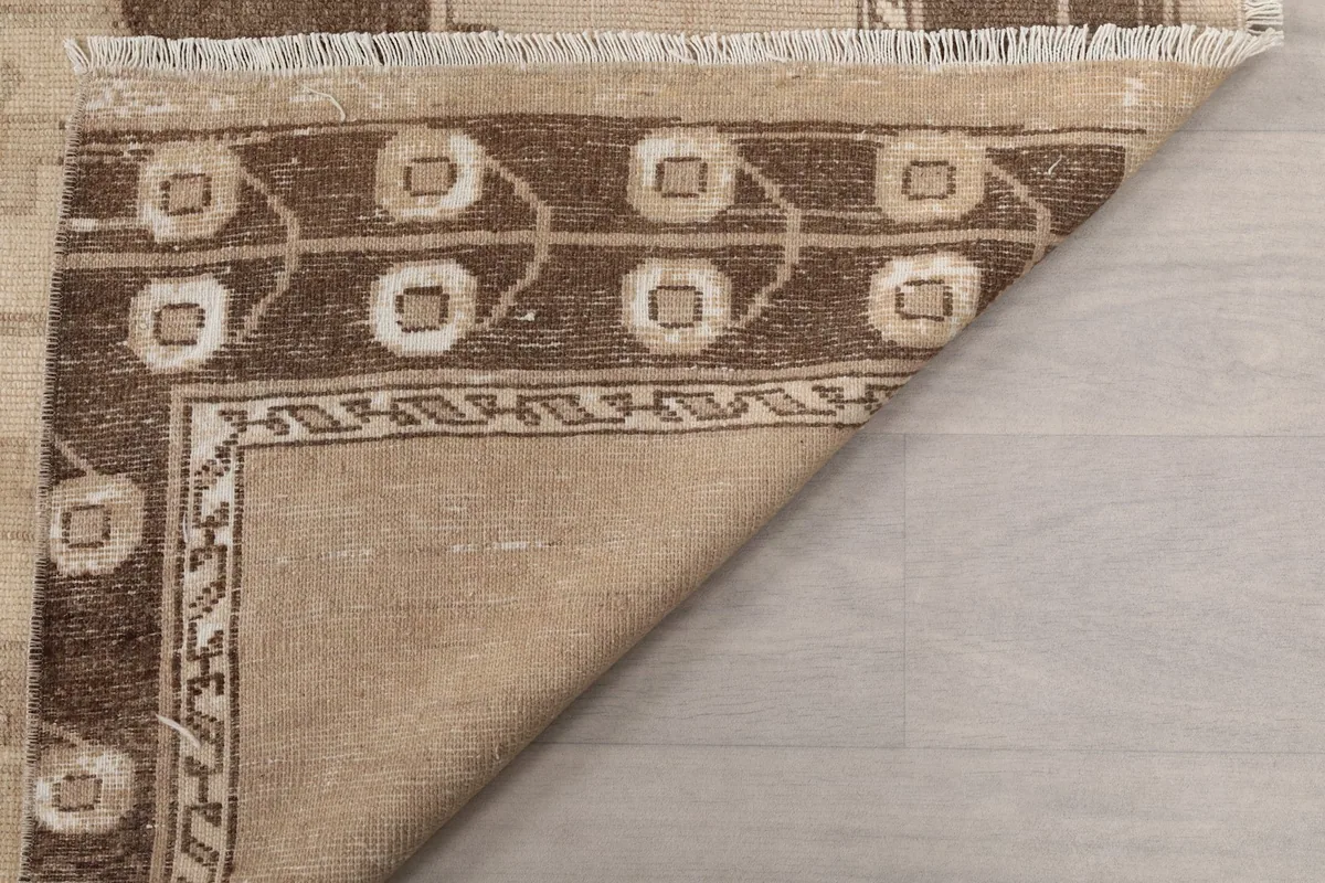 Underside view of the rug, showing the hand-knotted backing and cotton foundation