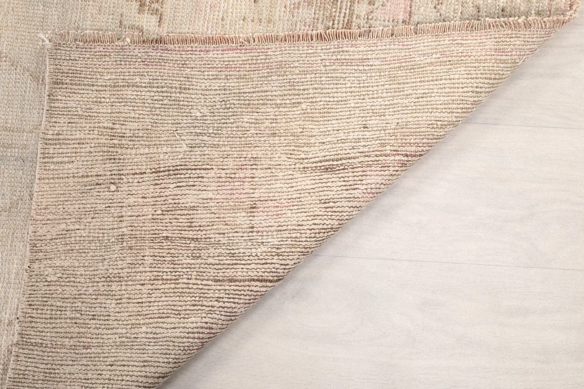 Another view of the rug's back, showing the consistent hand-knotted construction on the cotton foundation.