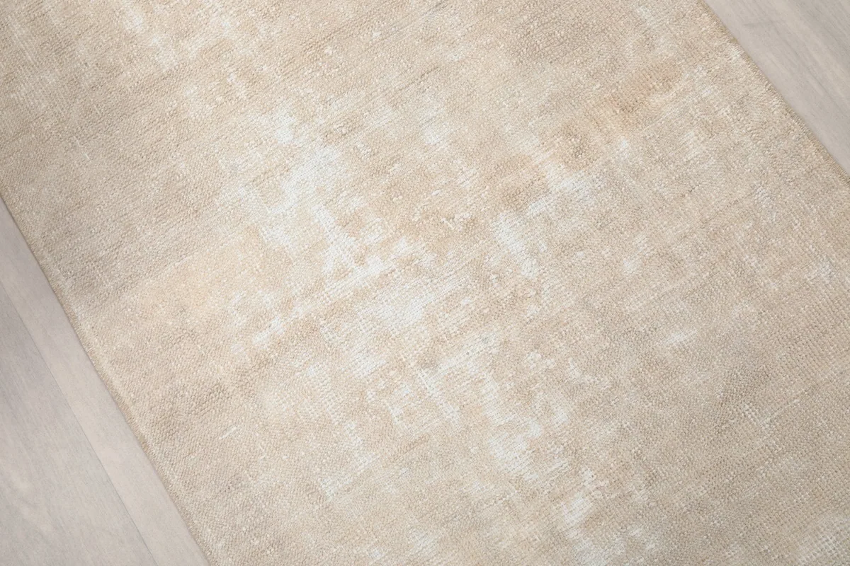 Angled view showcasing the faded texture and low pile of the vintage runner