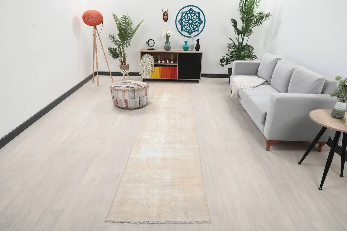 Runner rug in a modern living space with a gray sofa and wooden furniture