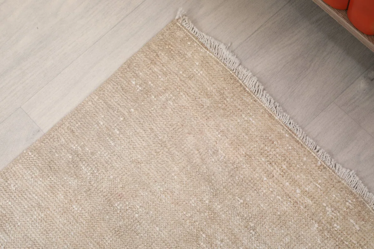 Detail of the rug's edge, showing the finished side and fringe
