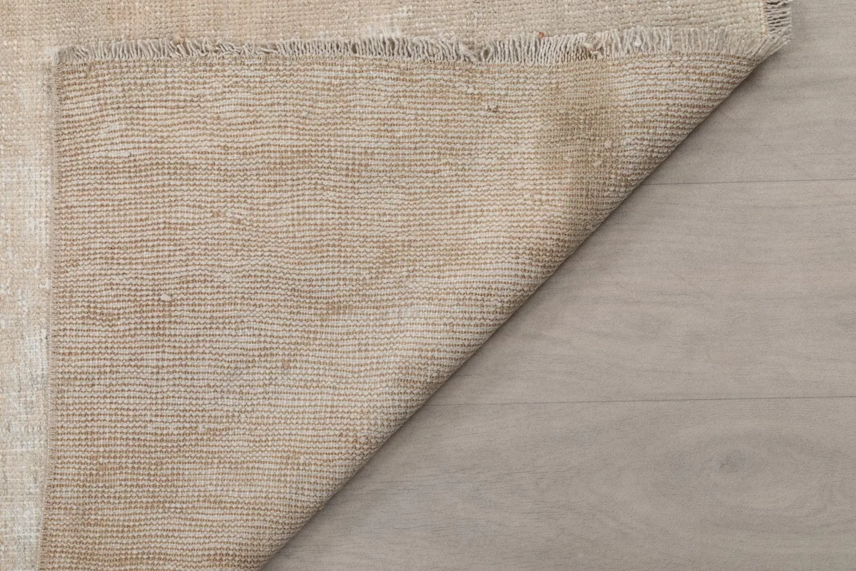 Reverse side of the rug, showing the hand-knotted construction and cotton foundation
