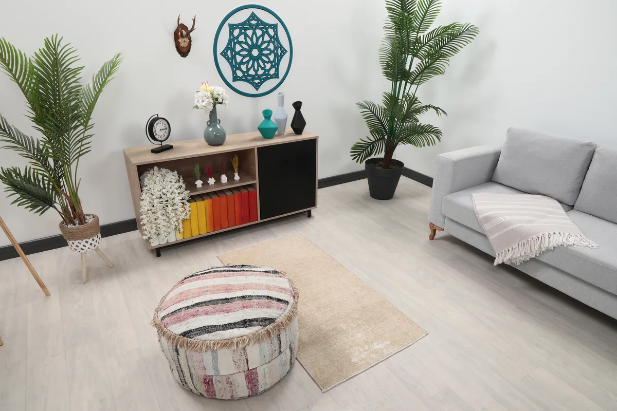 Faded Beige Geometric Anatolian Rug from an elevated angle within a room setting.