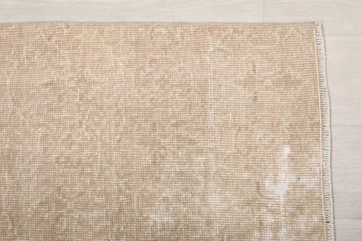 Detail of the Faded Beige Geometric Anatolian Rug's texture and subtle color variations.